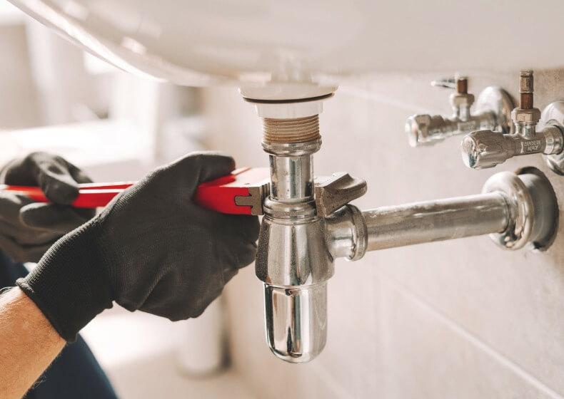 emergency plumbing repair in progress in a kitchen